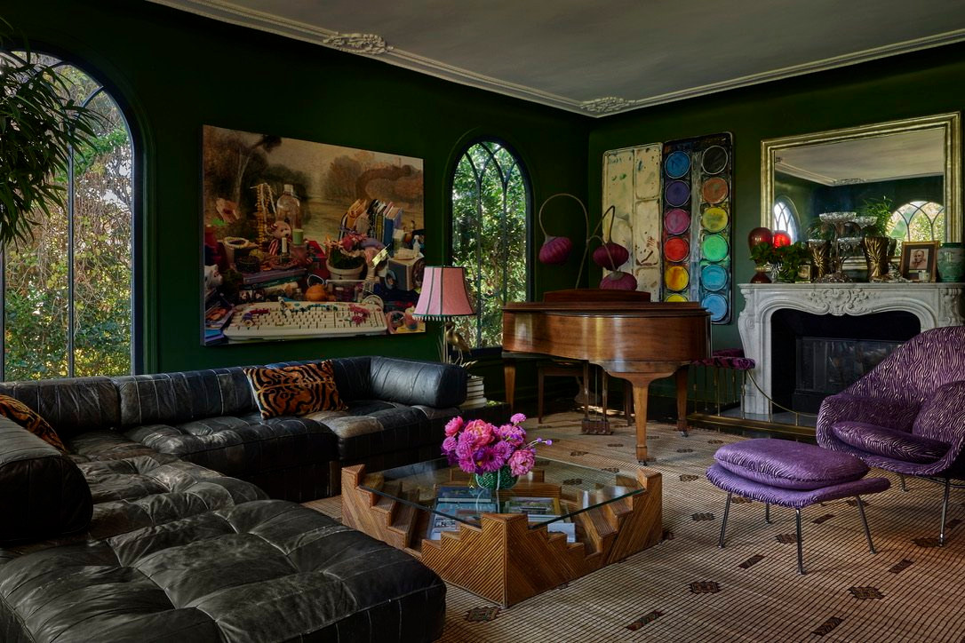 Bold, layered bedroom by Studio Nauleau with fern wallpaper, a burgundy headboard, and an arched window in a San Francisco residential interior