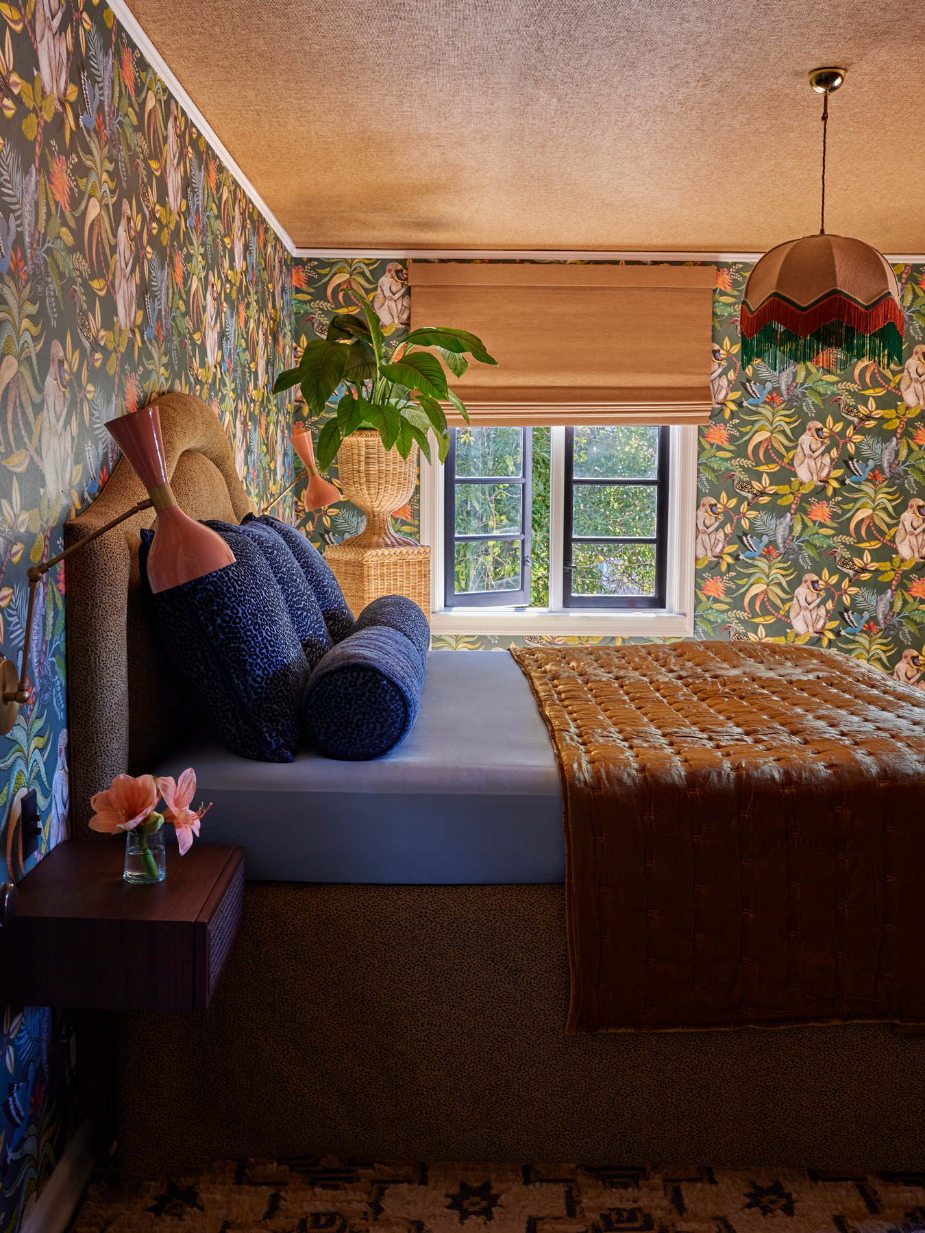 Studio Nauleau bedroom with floral wallpaper, a terracotta ceiling, and a layered blue bed in a San Francisco residence